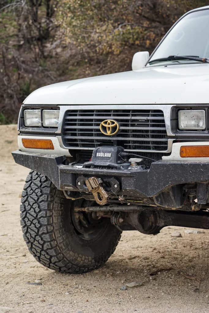 Close-up of a Toyota Land Cruiser FZJ80 front grille and aftermarket winch bumper